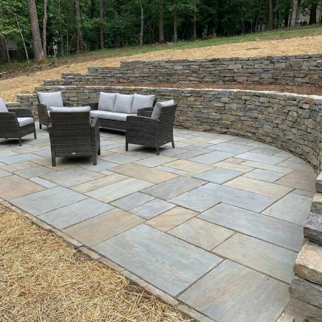 a patio with a retaining wall